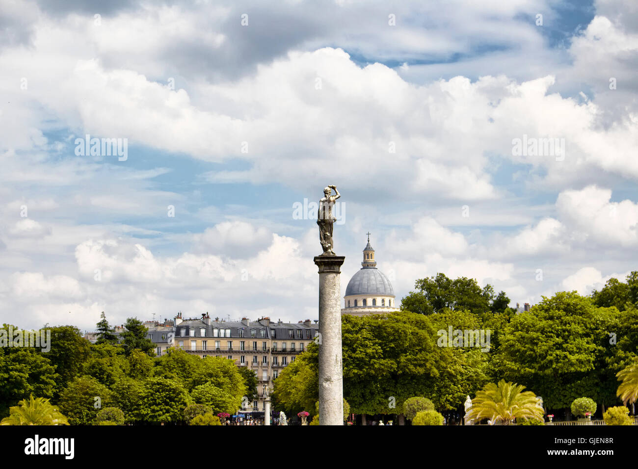 Woman statue with clouds and cityscape background at Jardin Du Luxembourg in Paris Stock Photo