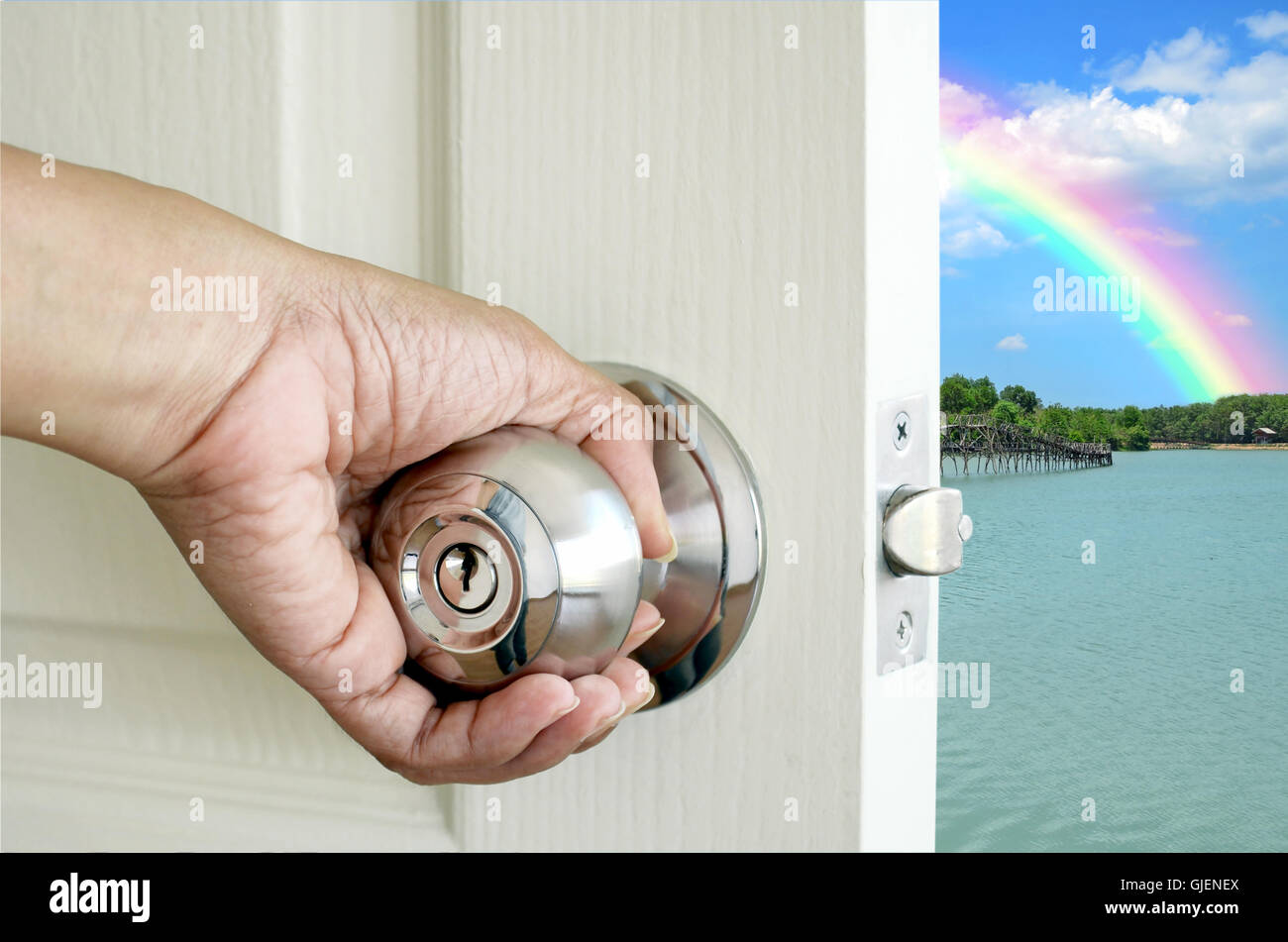 Left hand open the door isolated on nature background with clipping path. Stock Photo