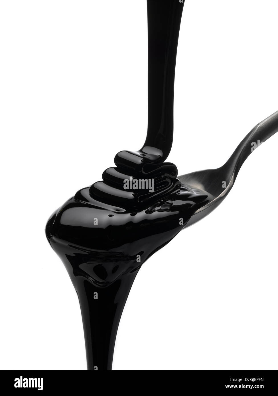 Molasses pouring onto a spoon Stock Photo Alamy