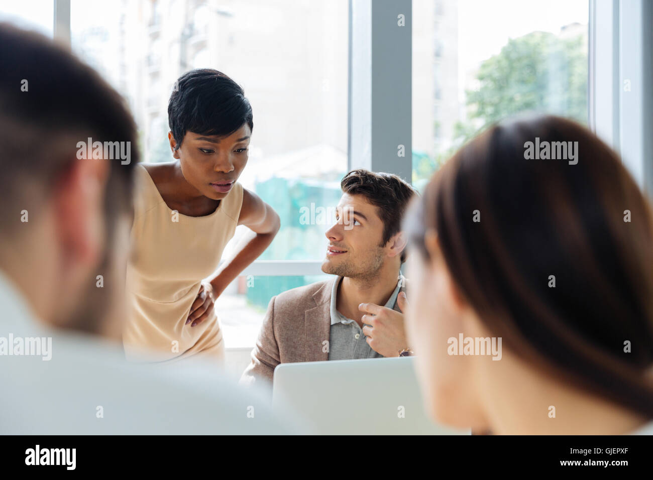 Happy young businesspeople at meeting in office Stock Photo