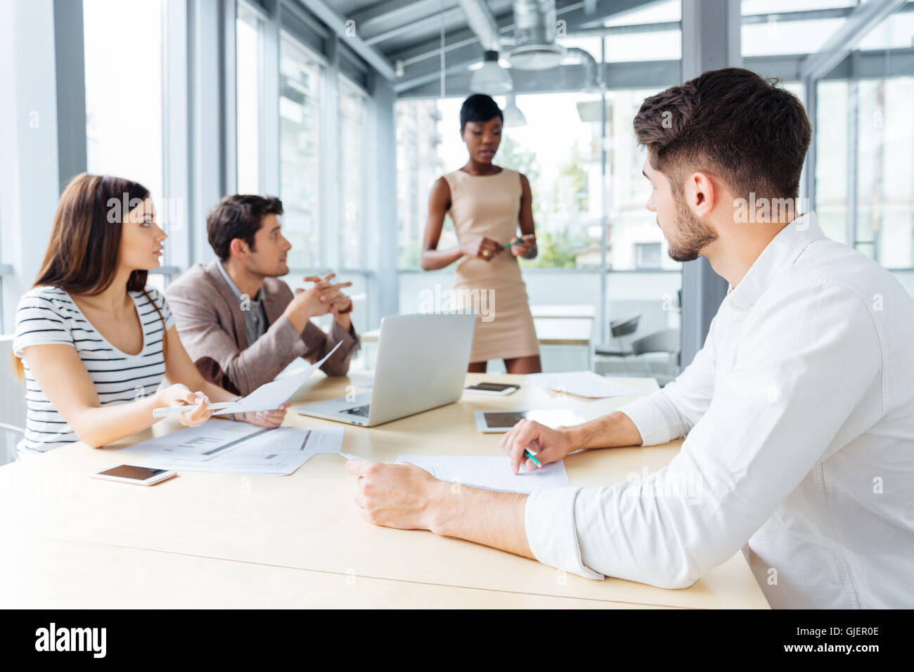 Businesspeople sitting at the table on a meeting at the office Stock Photo