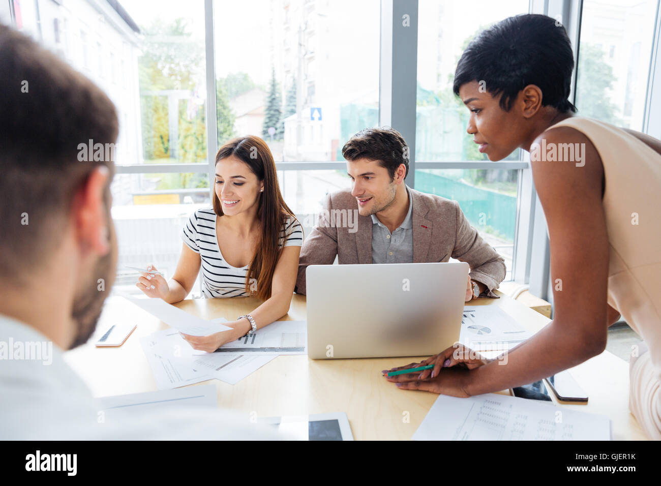 Group of young business people working with laptop tohether in office Stock Photo