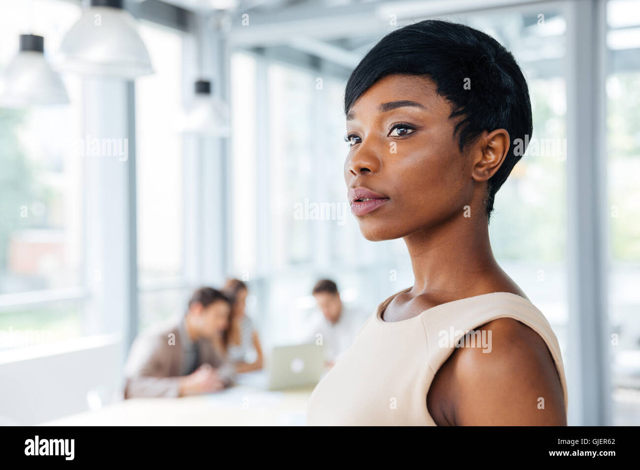 Closeup of serious beautiful african american young businesswoman standing in office Stock Photo