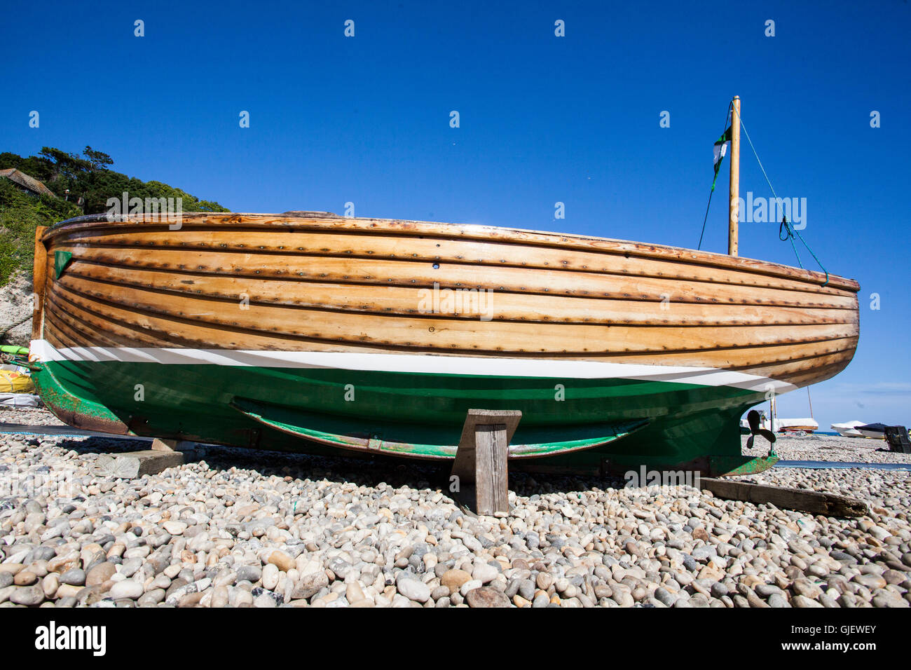 clinker built boat on seashore of pebbles Beer Devon Stock ...