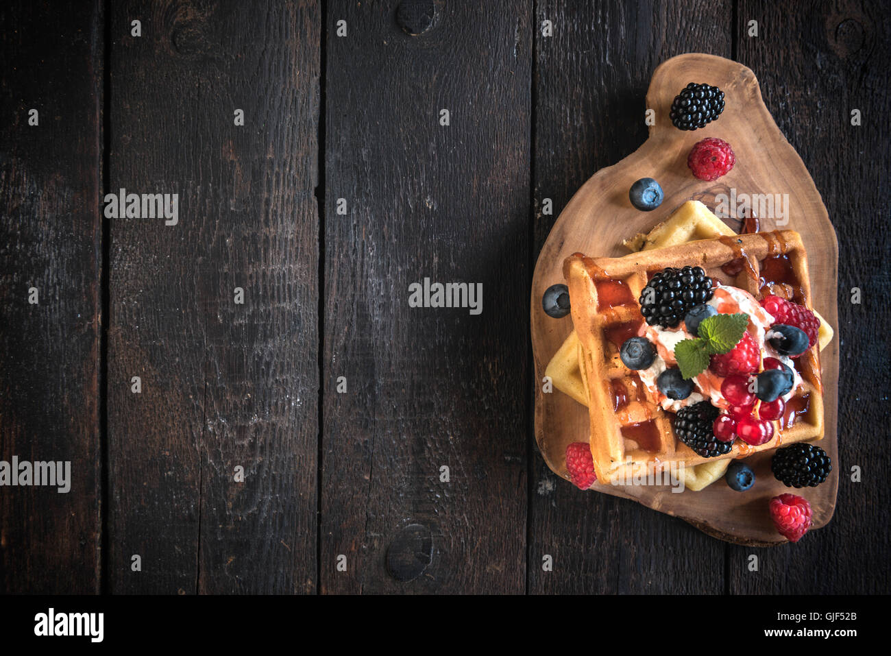 Traditional Belgium waffles with berry fruits and ice cream on wooden ...