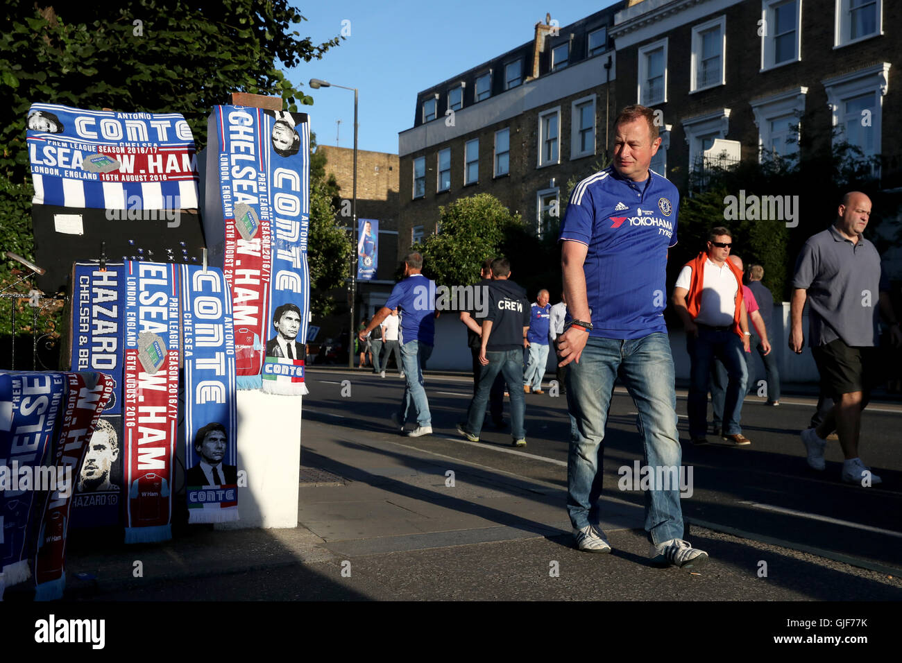 Chelsea fans look at merchandise for sale outside the ground before the Premier League match at Stamford Bridge, London. Stock Photo