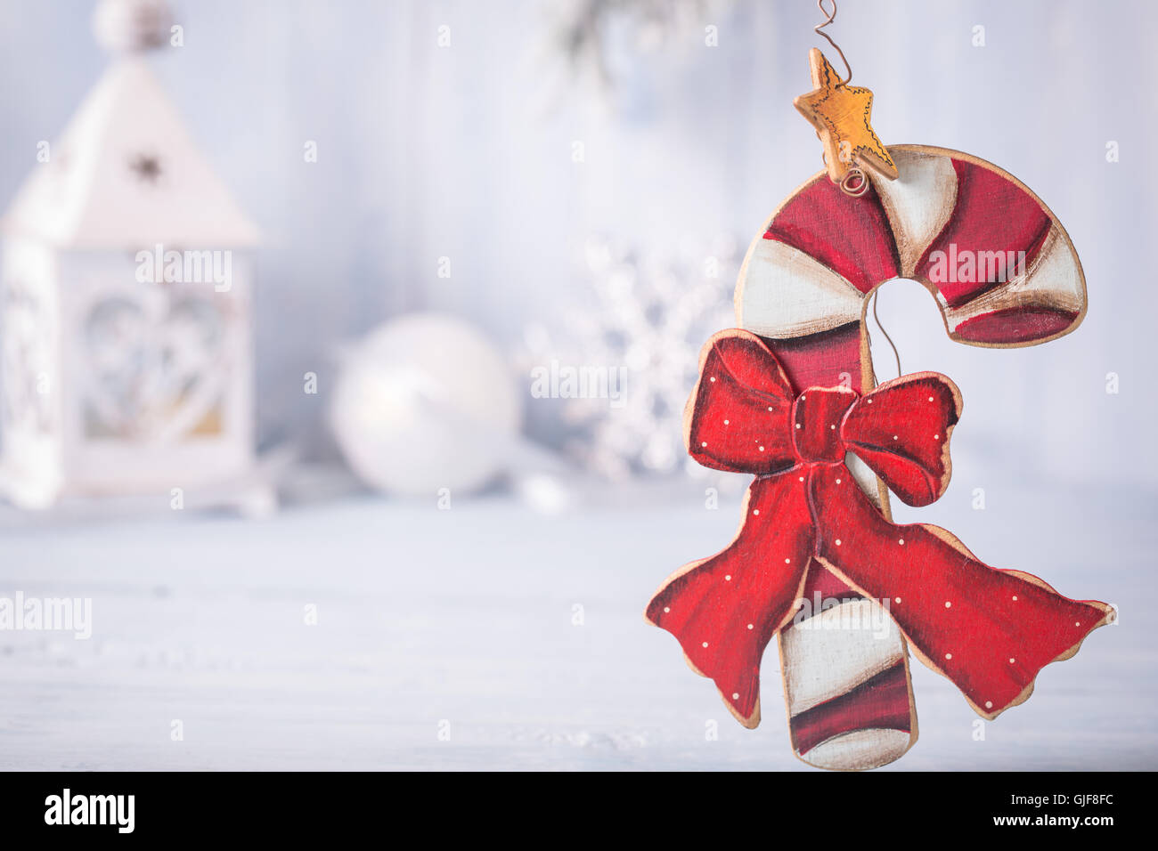 Christmas candy cane decoratin from right side of blue backgroun Stock Photo