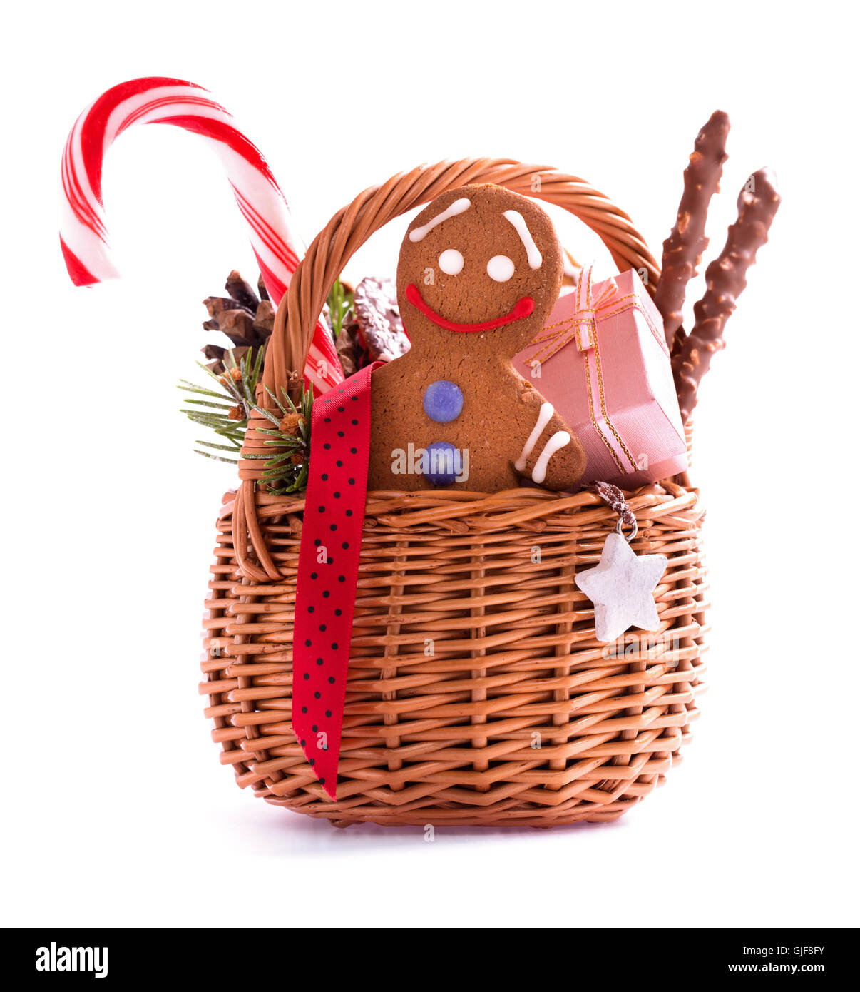 Christmas gift basket with treats and gingerbread man isolated Stock Photo