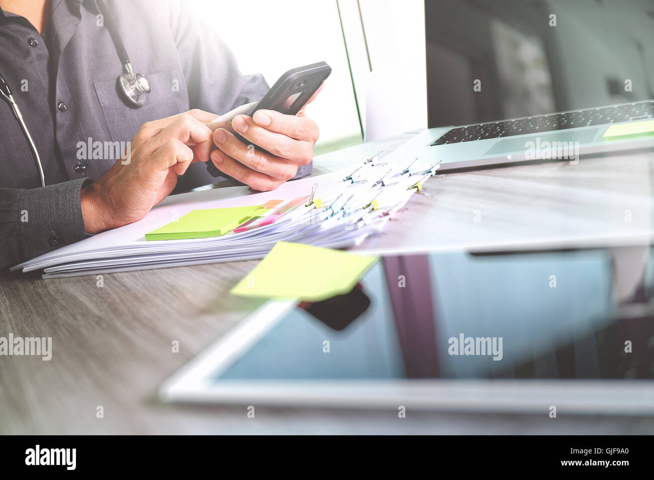 Medicine doctor hand holding modern digital smart phone and laptop ...