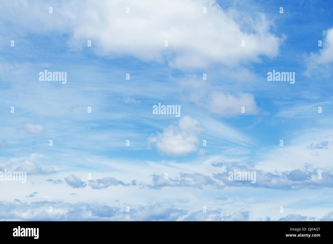 Fluffy clouds in a blue sky Stock Photo