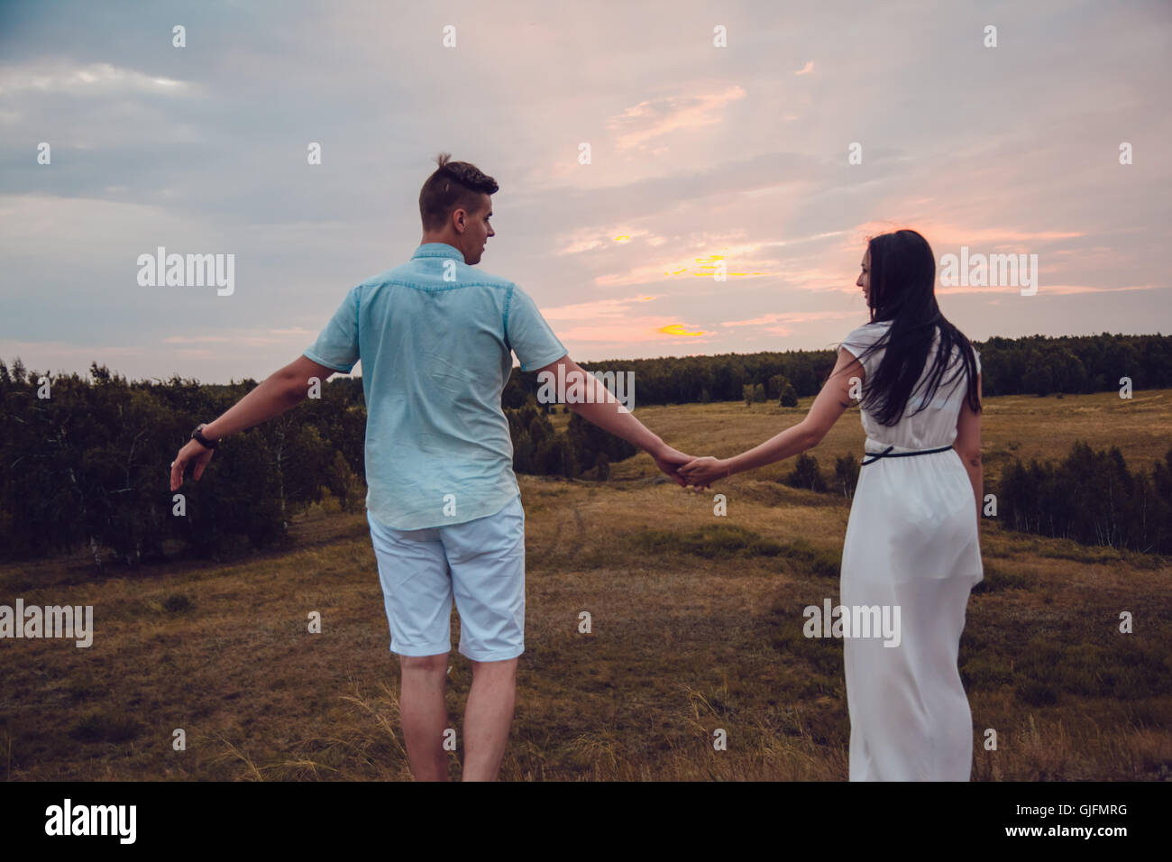 Love story. In love couple walking on sunset background. Silhouette ...