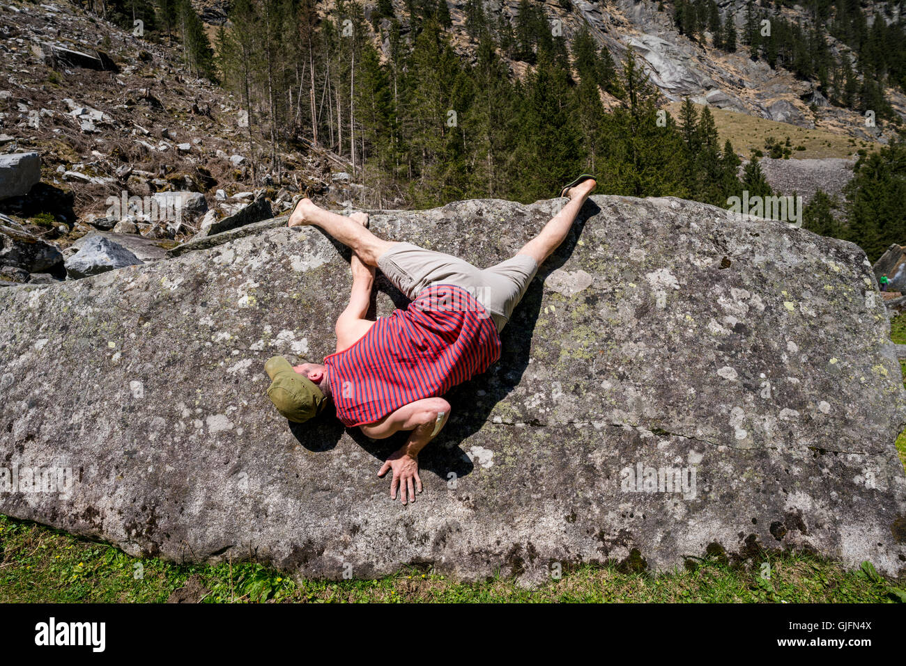 Bouldering, or rock climbing without ropes, in the Sunderground area of Zillertal, Austria in spring. Stock Photo