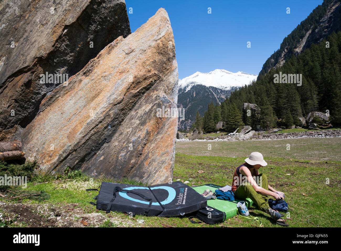 A woman bouldering, or rock climbing without ropes, in the Sunderground