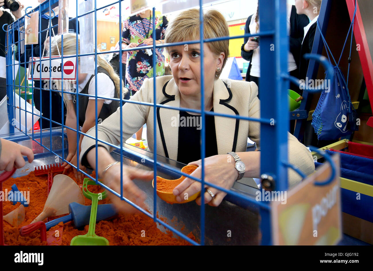 First Minister Nicola Sturgeon plays in the sand pit with P1 pupils during a visit to Burnfoot Community School, Hawick, to announce funding to raise educational attainment in deprived areas. Stock Photo