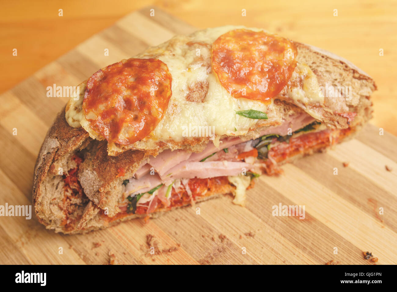 Tasty homemade sandwich on kitchen cutting board Stock Photo