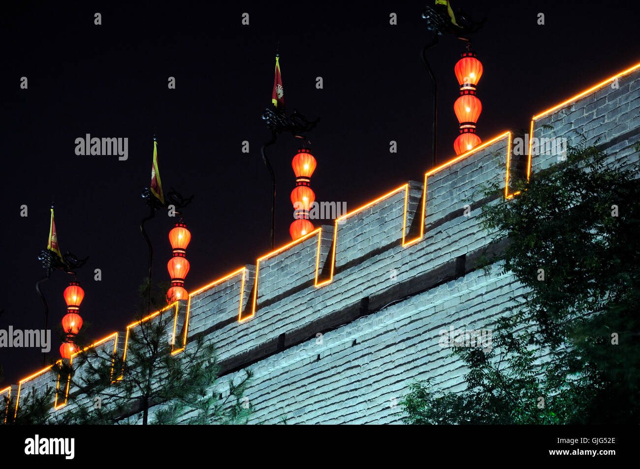 Red lanterns lit up at night and hanging down on top of the Xian city ...