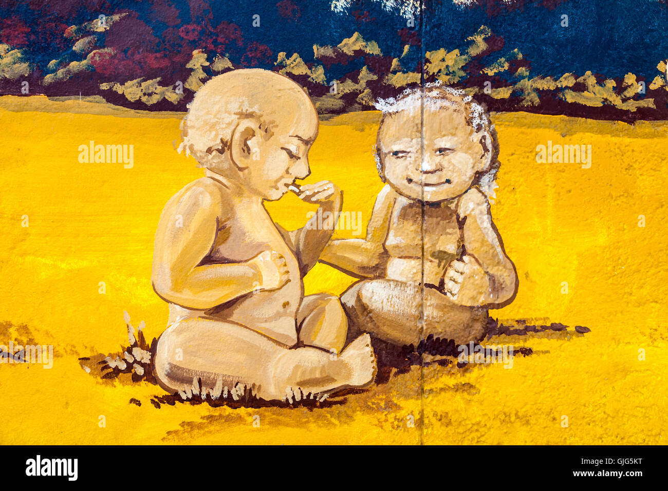 Detail of graffiti mural on the Berlin wall showing two aged babies, East Side Gallery, Friedrichshain, Berlin, Germany. Stock Photo