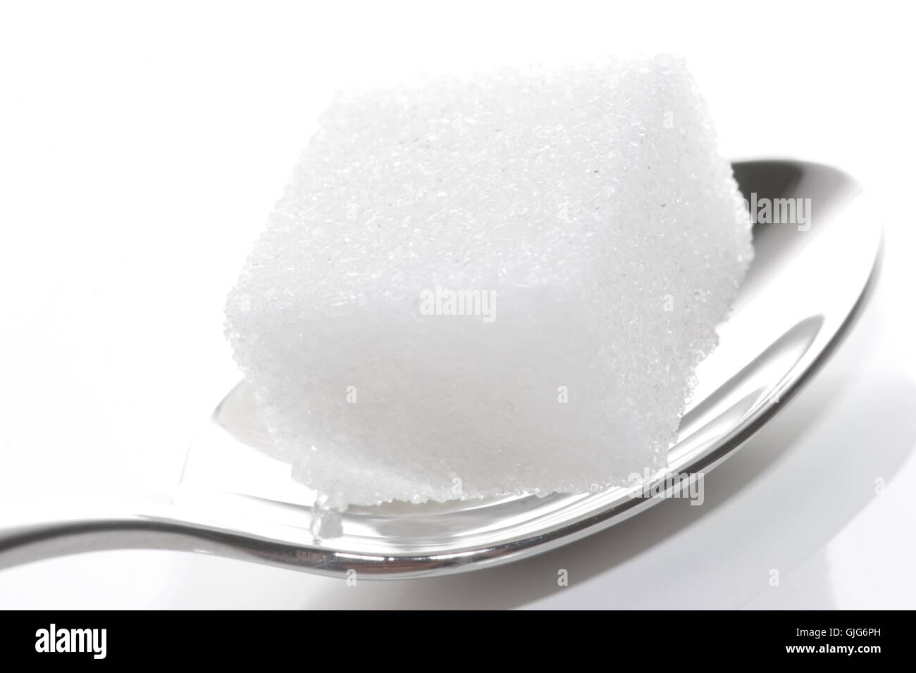 sugar cubes on a teaspoon Stock Photo Alamy