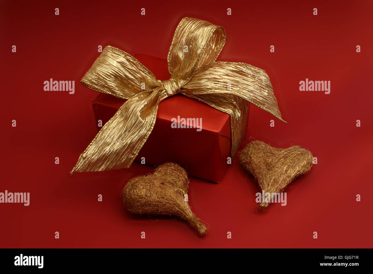 Gift box with gold coloured wrapping paper and a black ribbon and bow Stock  Photo - Alamy