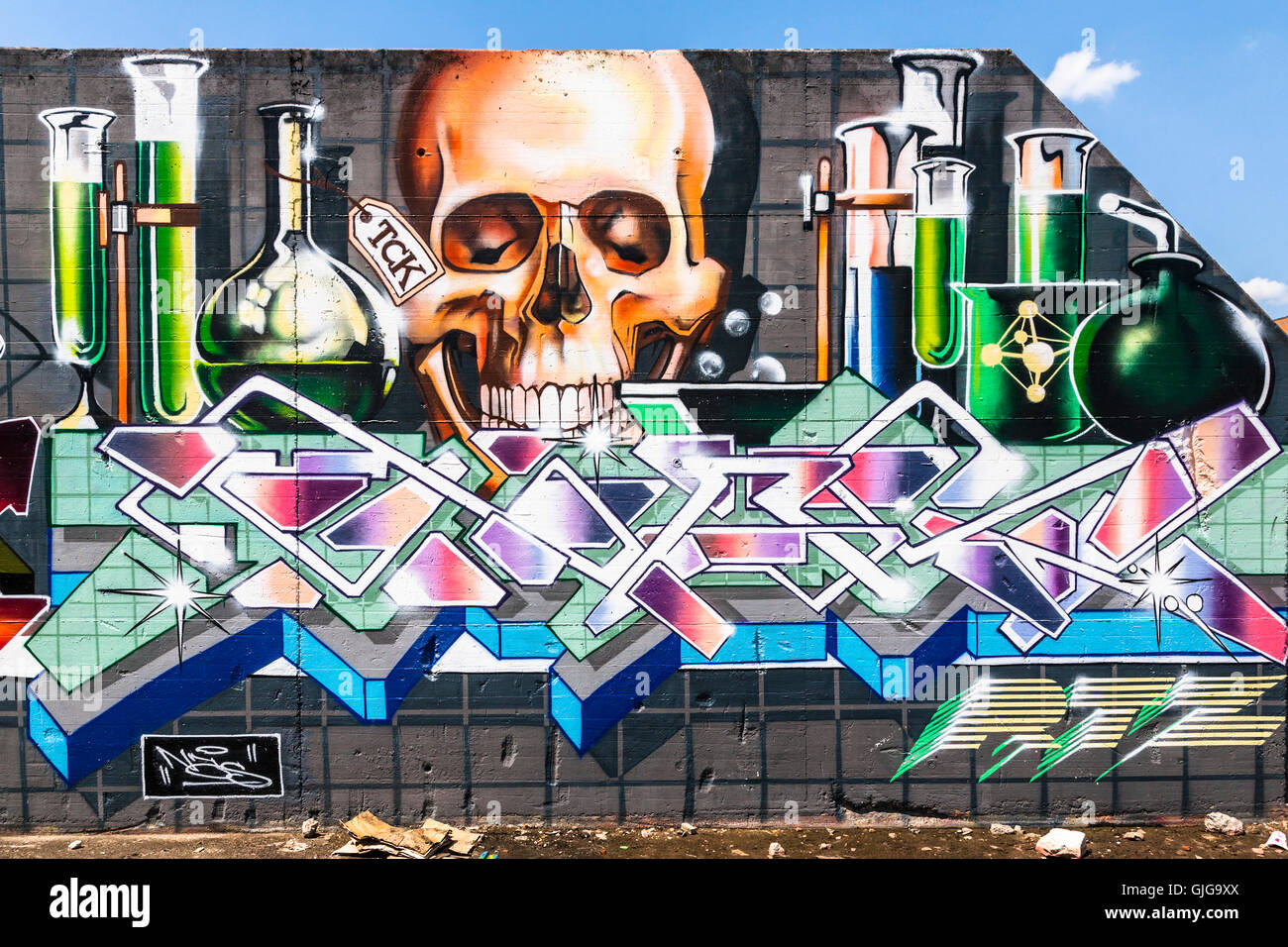 Graffiti Skull and test tubes sprayed on the remnant of an old wall, Friedrichshain, Berlin, Germany. Stock Photo