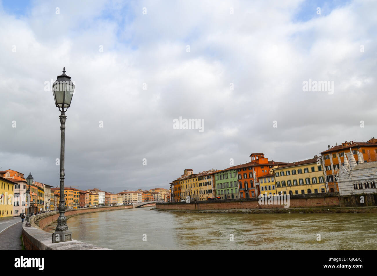 Traditional colourful houses on the bank of Arno River, Pisa, Italy Stock Photo