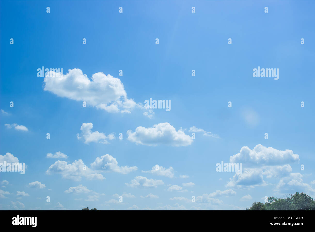 White fluffy clouds in the blue sky Stock Photo