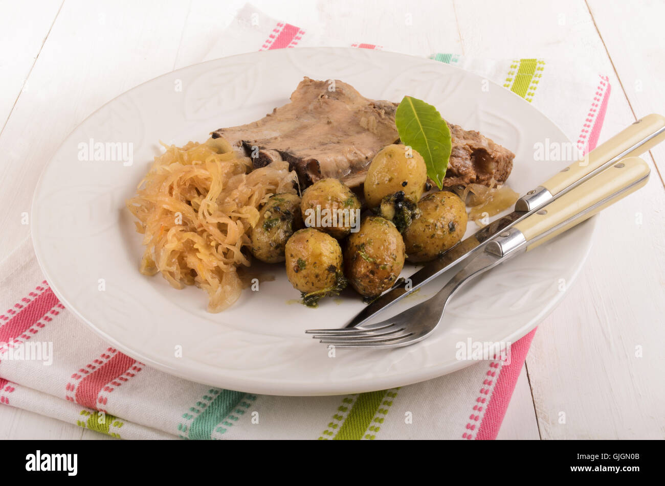 pickled cabbage with boiled pork ribs and spicy potatoes on a plate Stock Photo