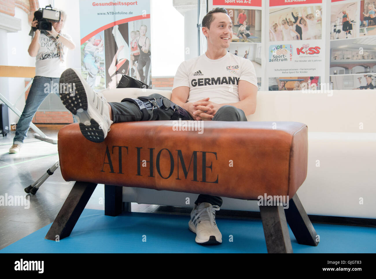 Hanover, Germany. 16th Aug, 2016. Injured gymnast Andreas Toba sitting during a reception by his home club - Turn-Klubb zu Hannover - in Hanover, Germany, 16 August 2016. Toba competed on the pommel horse during the Olympic Games in Rio, despite a cruciate rupture he had suffered previously. He competed despite being in great pain, helping the German squad get through to the team finals. PHOTO: JULIAN STRATENSCHULTE/DPA/Alamy Live News Stock Photo