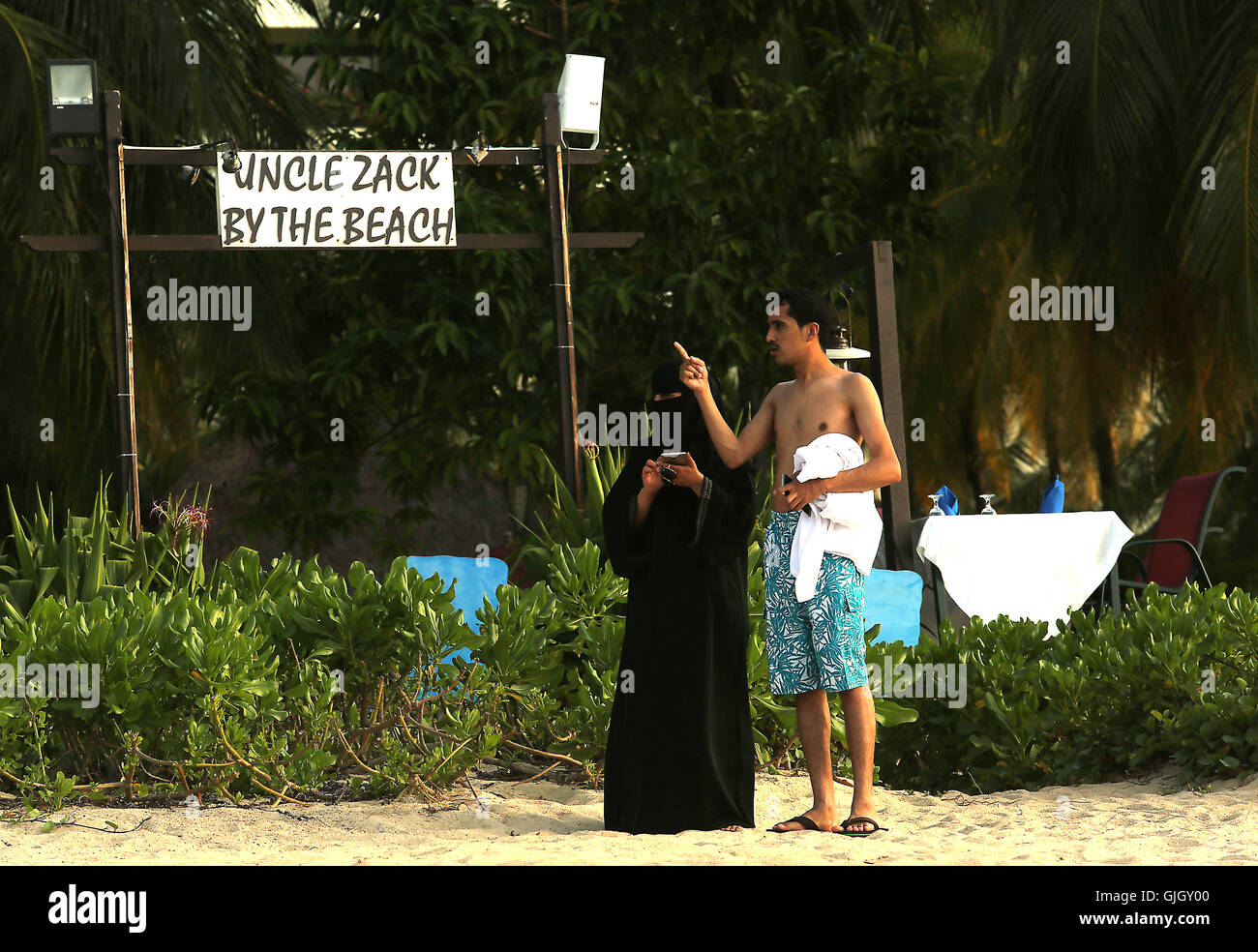 Penang, MALAYSIA. 24th Feb, 2016. Muslim women, wearing full burqas, and men enjoy a day at the beach in Penang, Malaysia on February 21, 2016. The mayor of Cannes in southern France has banned full-body swimsuits known as ''burkinis'' from the beach, citing public security concerns and fears. © Stephen Shaver/ZUMA Wire/Alamy Live News Stock Photo