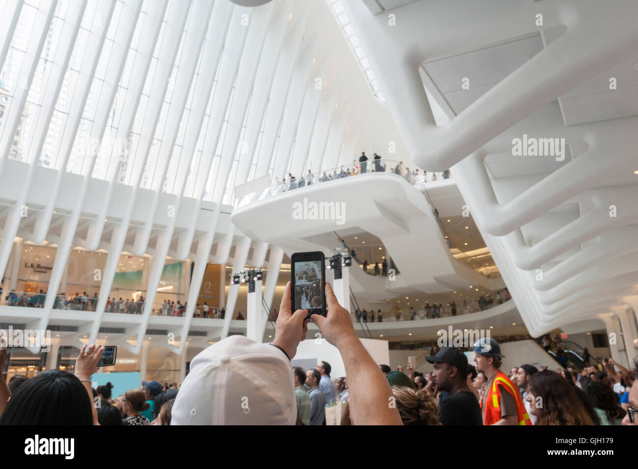 Thousands of visitors pack the World Trade Center Transportation Hub, known as the Oculus, on Tuesday, August 16, 2016 for the grand opening of the retail spaces. The 350,000 square foot retail space will feature over 100 stores when they all open, including a now opened Apple Store. The mall opens almost 15 years after the World Trade Center terrorist attack.  (© Richard B. Levine) Stock Photo