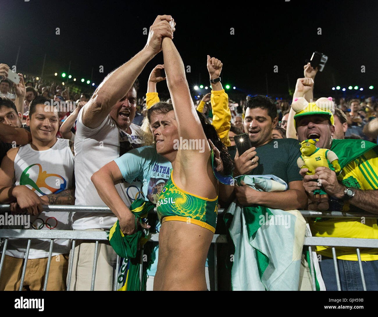 Rio de Janeiro, RJ, Brazil. 17th Aug, 2016. OLYMPICS BEACH VOLLEYBALL :Agatha Rippel Bednarczuk (BRA) celebrates with supporters after beating Kerri Walsh Jennings (USA) and April Ross (USA) in the semifinals at Beach Volleyball Arena during the 2016 Rio Summer Olympics games. Credit:  Paul Kitagaki Jr./ZUMA Wire/Alamy Live News Stock Photo