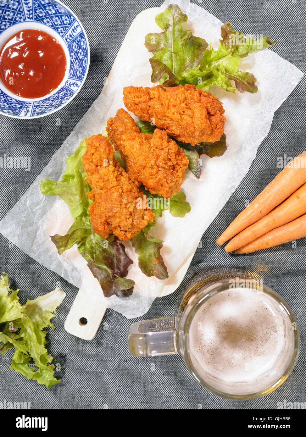 Fried chicken wing with beer and carrot Stock Photo