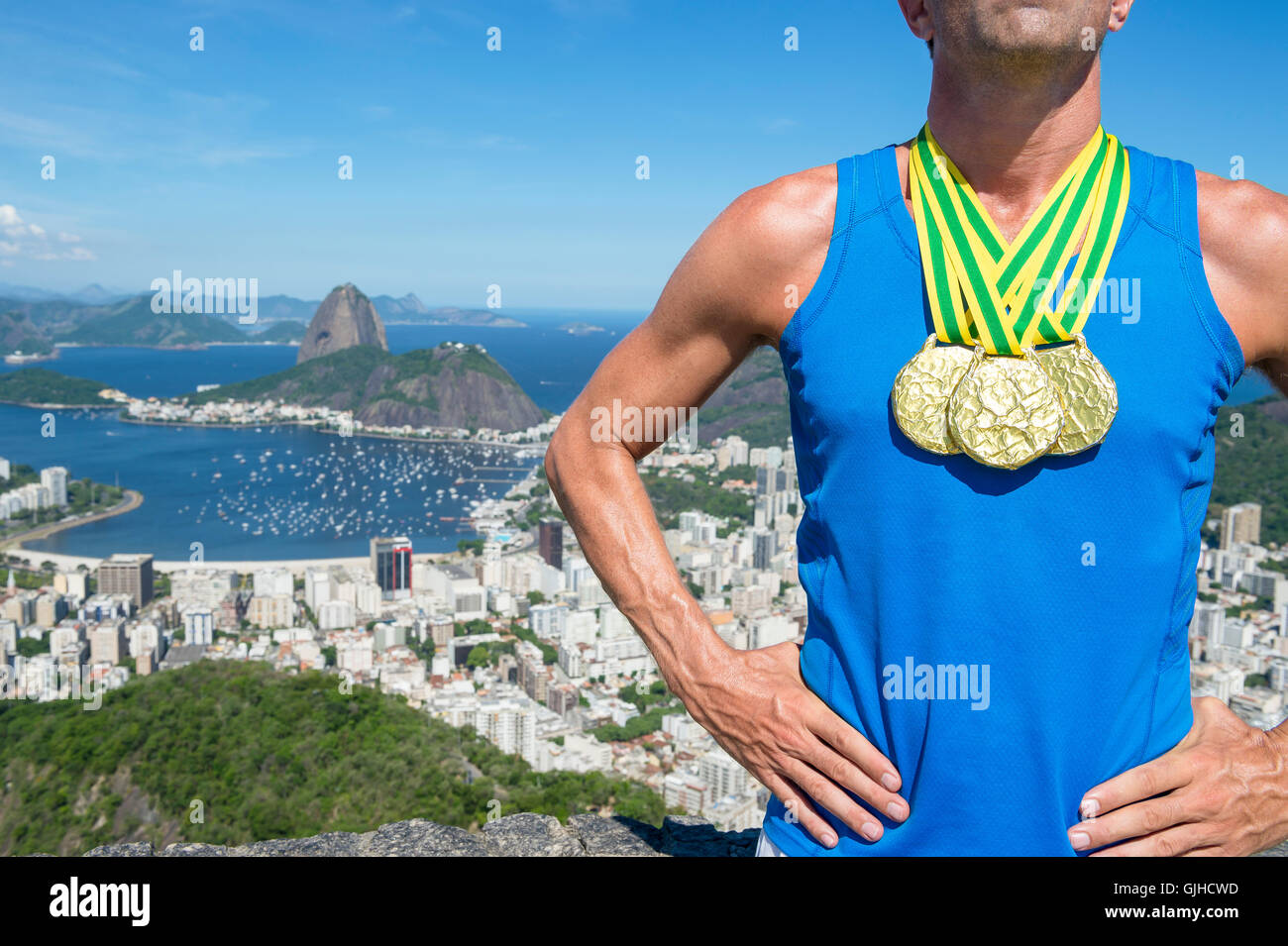 Gold medal champion athlete standing at a scenic skyline overlook of Rio de Janeiro, Brazil Stock Photo