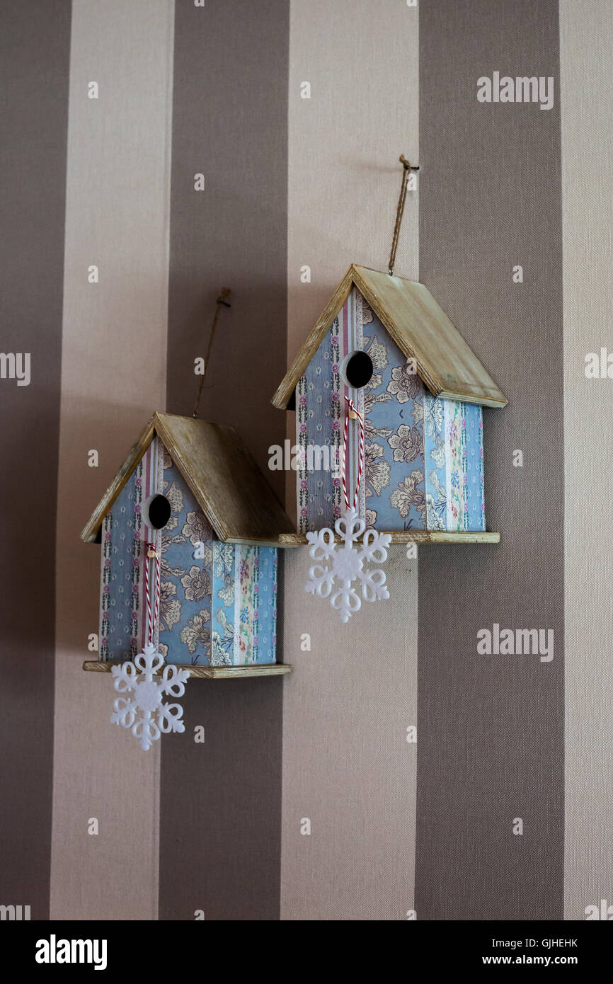 Two decorative birdhouses hanging on wall Stock Photo Alamy