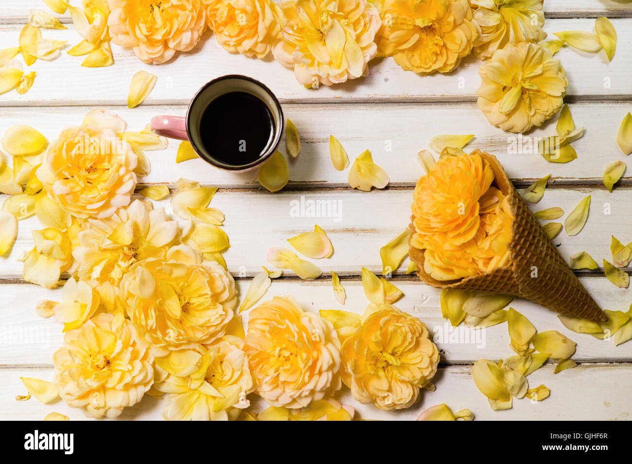 Yellow roses, Conceptual  ice-cream cone and cup of coffee Stock Photo