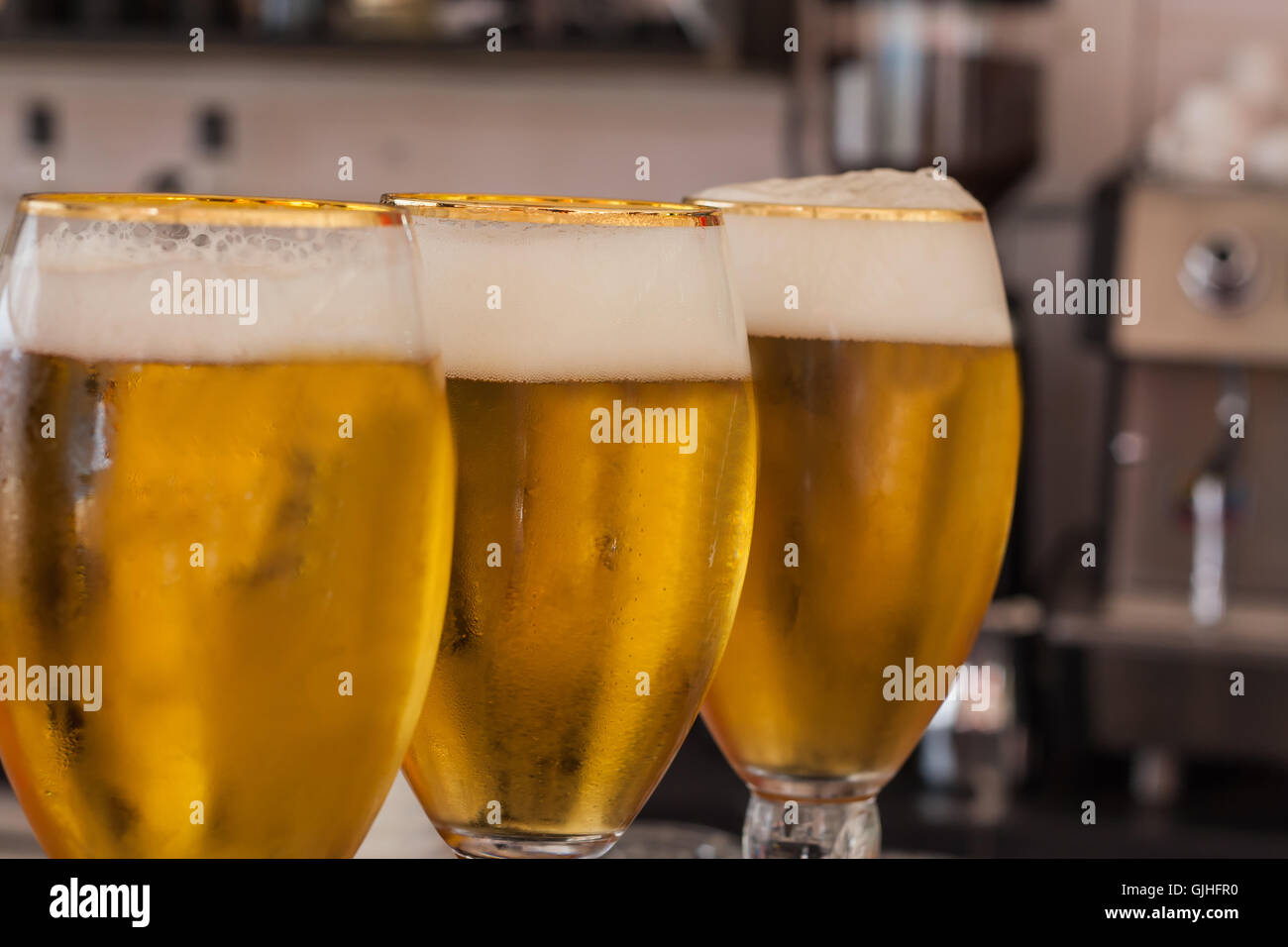 Three glasses of Fresh draught beer on bar Stock Photo