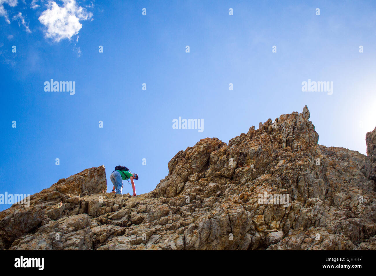Teenage boy reaching mountain peak, Borah Peak, Idaho, America, USA Stock Photo