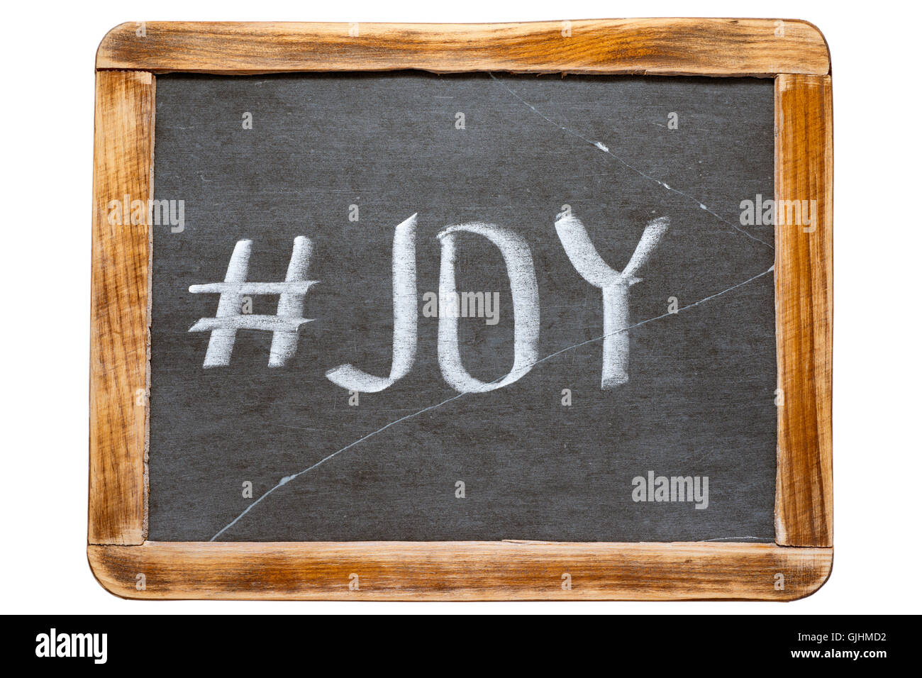 joy hashtag handwritten on vintage school slate board isolated on white Stock Photo