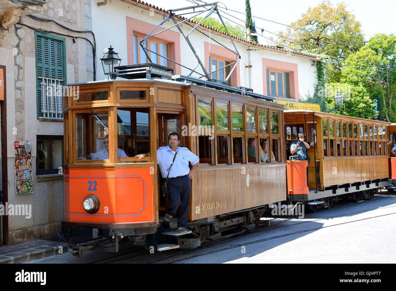 The tram is on street of Soller town and tourists,  Mallorca, Spain Stock Photo