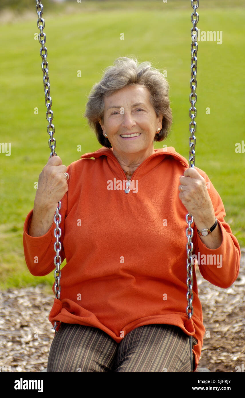 Older woman swinging hi-res stock photography and images - Alamy
