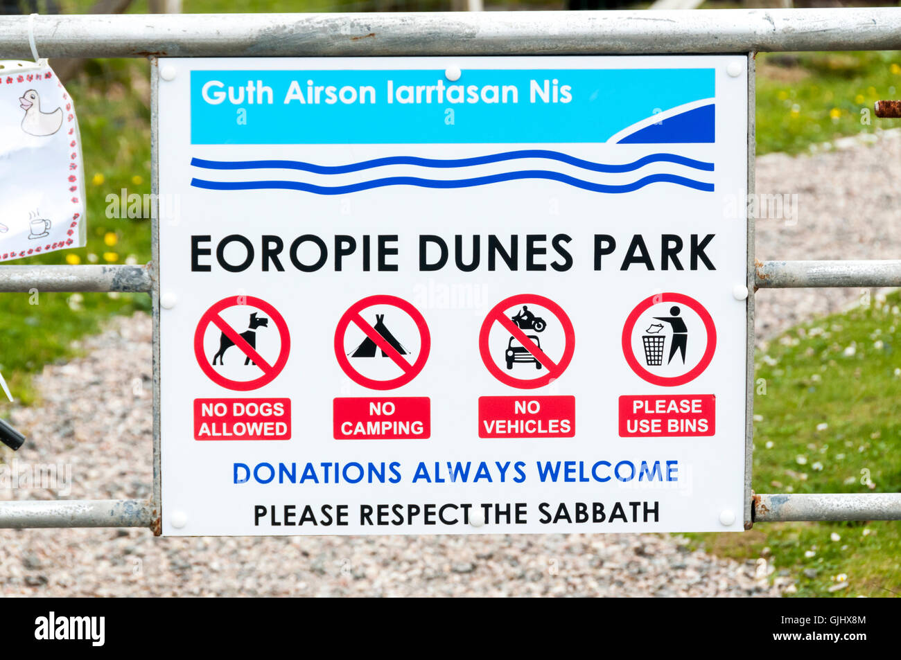 The entrance to a children's playground on the Isle of Lewis asks people to Please Respect The Sabbath. Stock Photo