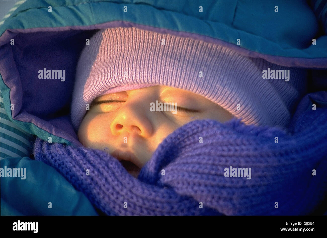 baby is sleeping deeply,evening sun,winter Stock Photo