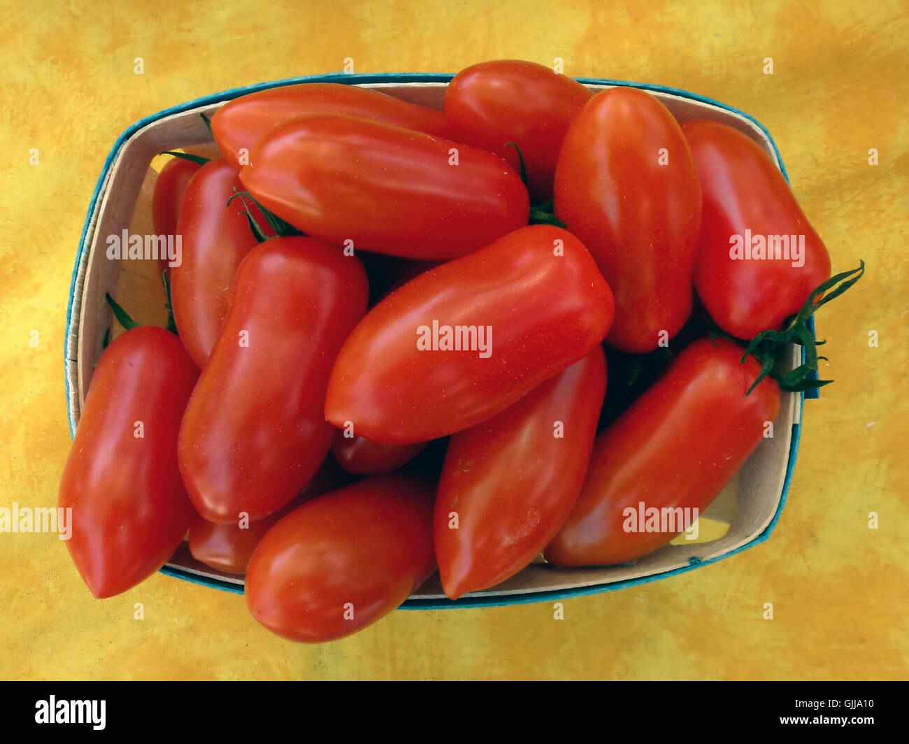 Tomatoes in a basket at a greengrocer Stock Photo - Alamy