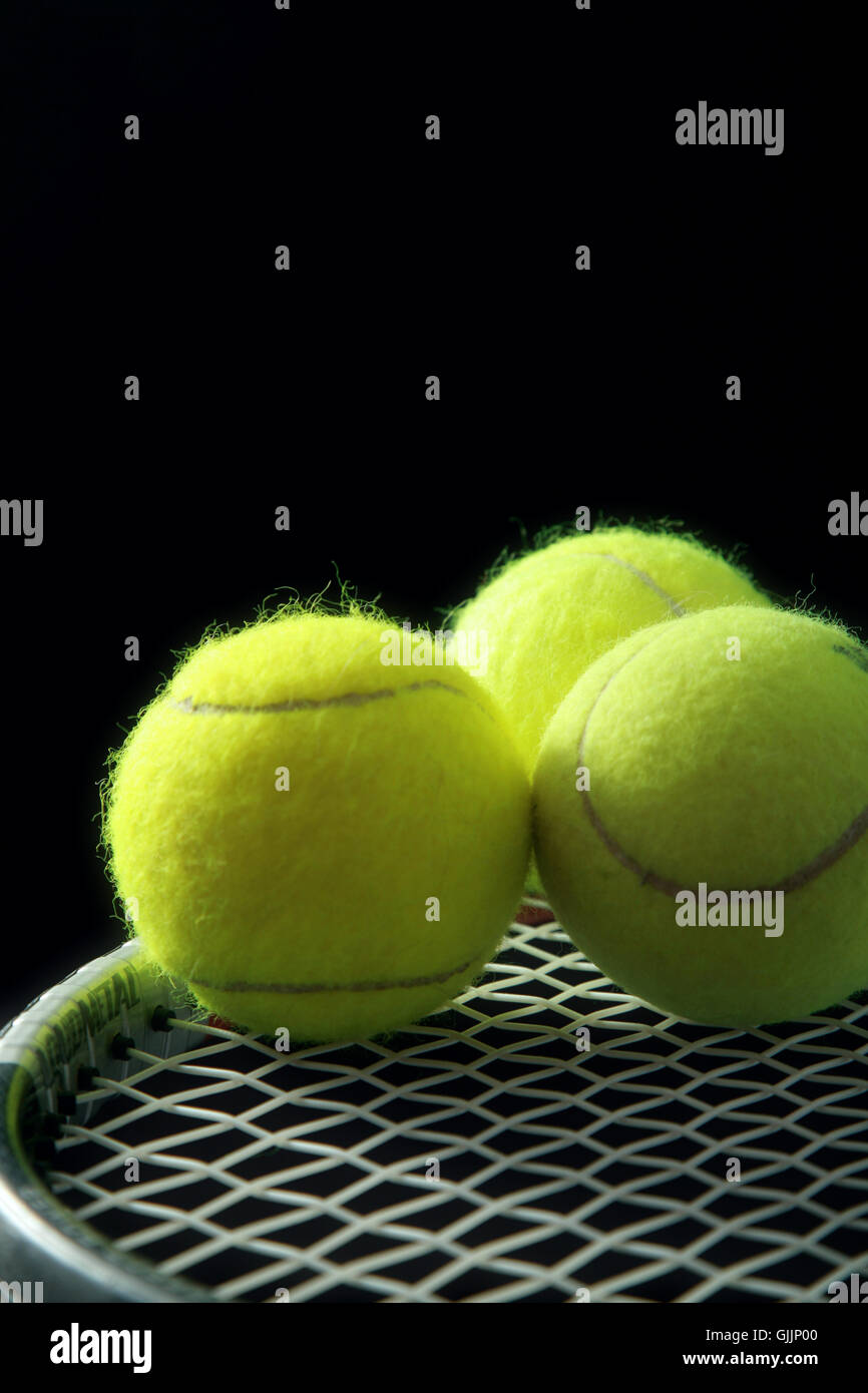 3 tennis balls on racket Stock Photo