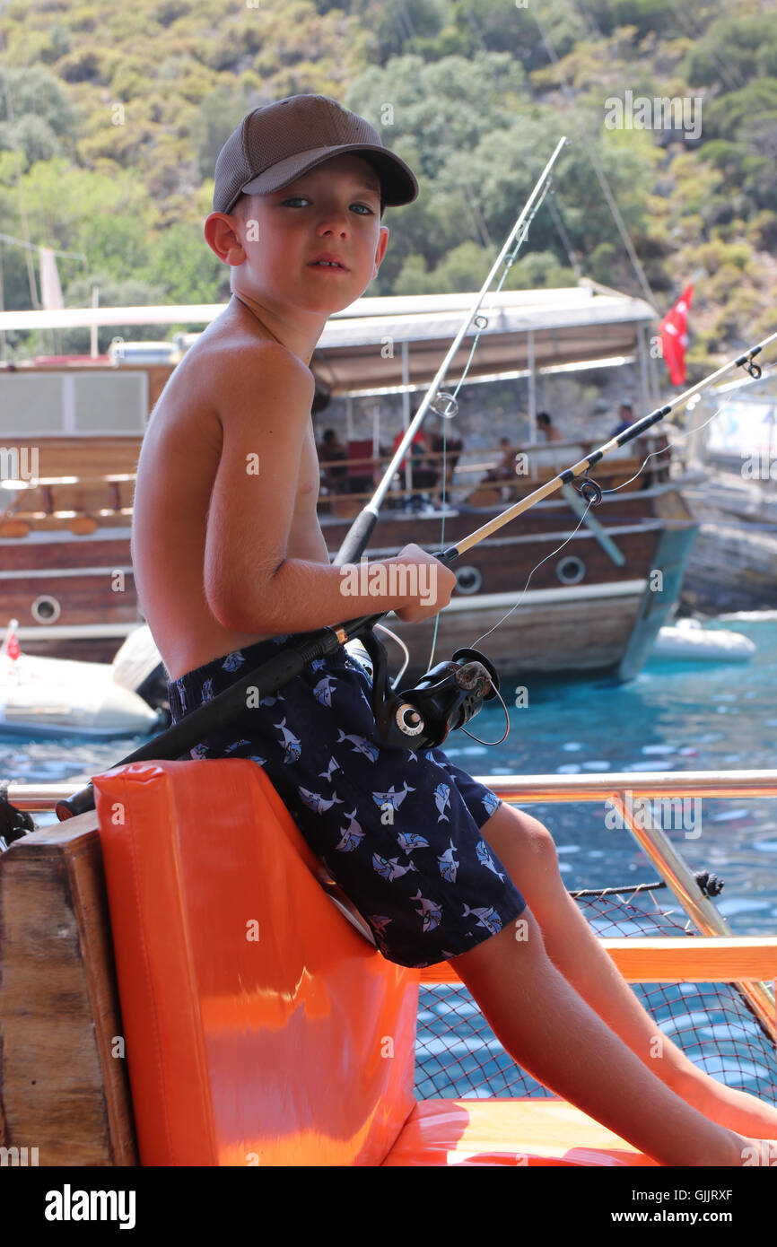 Boy relaxing in fishing boat hi-res stock photography and images - Alamy