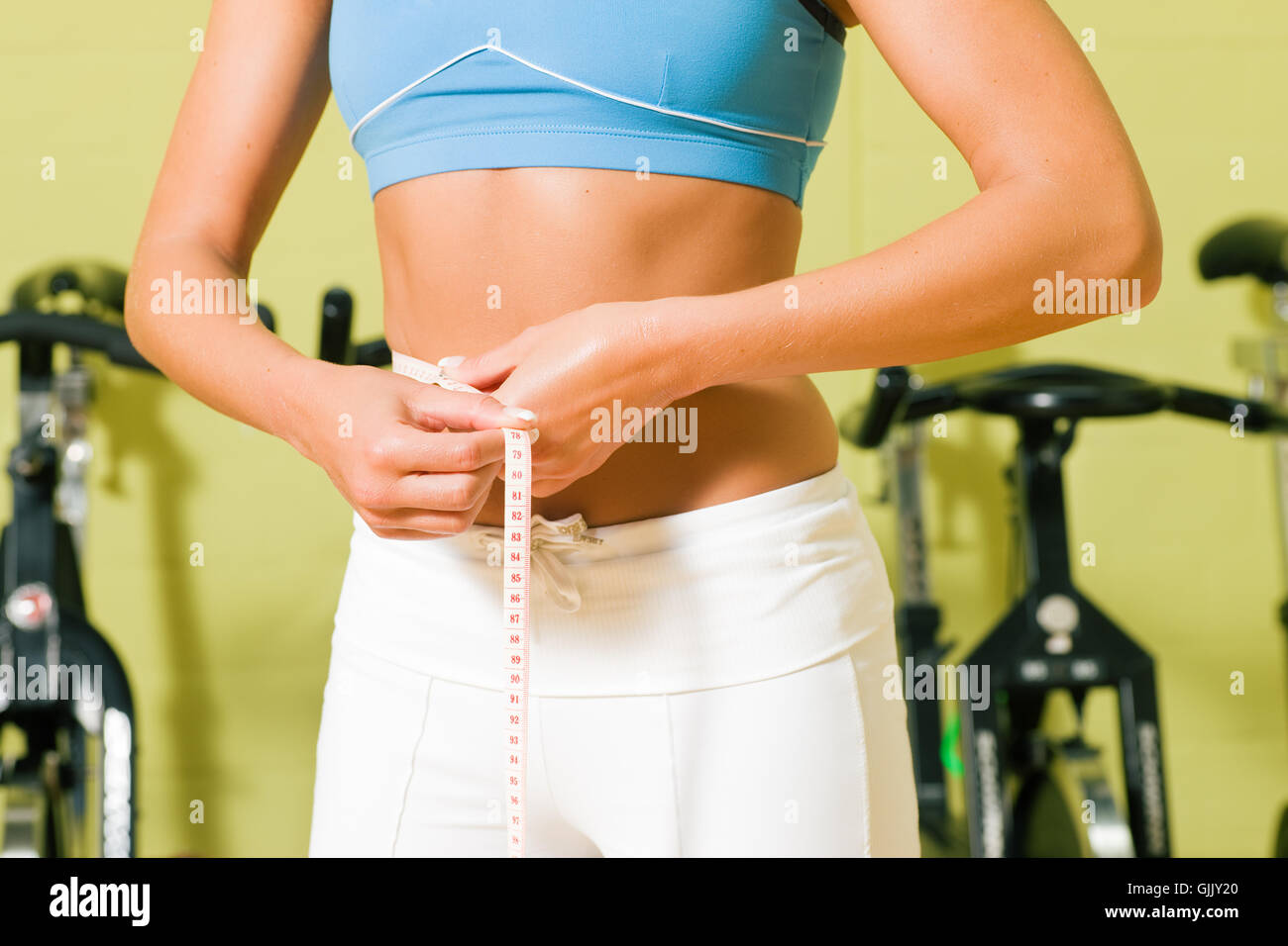 Premium Photo  Beautiful girl exercising use the waist tape measure to  check your waist circumference during daily