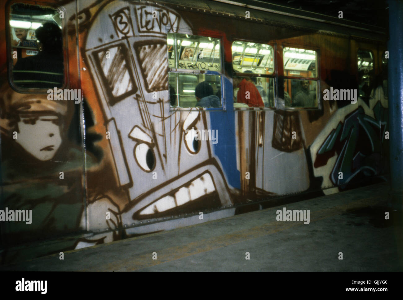 Illegal graffiti on a subway car in New York City. The mural was done by the subway artist Duster. Stock Photo