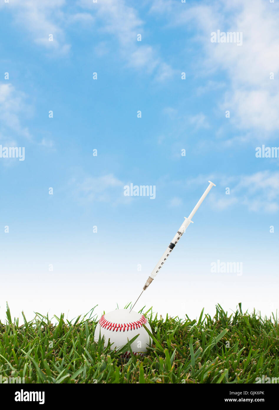 Baseball on grass with a syringe — performance enhancing drugs. Stock Photo