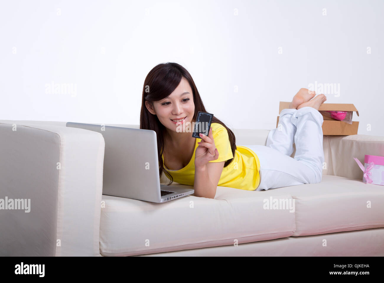 Studio shot Young woman showing product Stock Photo - Alamy