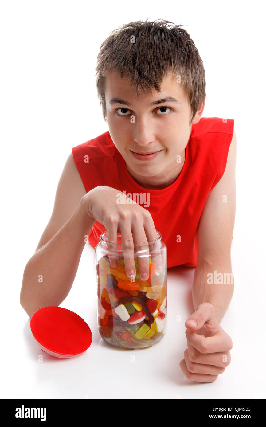 Boy with hand in lolly jar Stock Photo